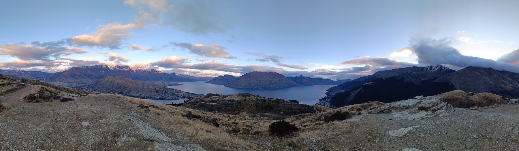 Panorama view of Lake Wakatipu. Remarkables to the east, Cecil Peak to the south and centre straight across the lake and Ben Lomond to the west.